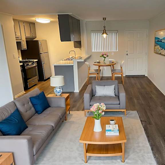 a living room with a grey couch and a wooden coffee table.