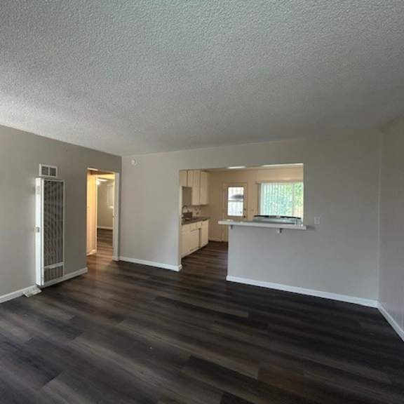 a room with a wooden floor and white walls.