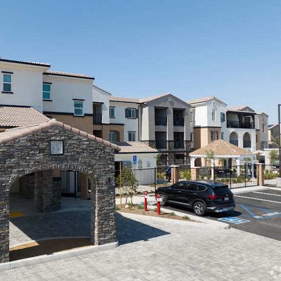 a building with an arch and a car parked in front of it