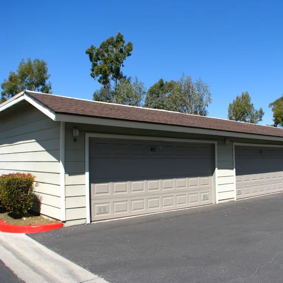 a two car garage with a driveway in front of it