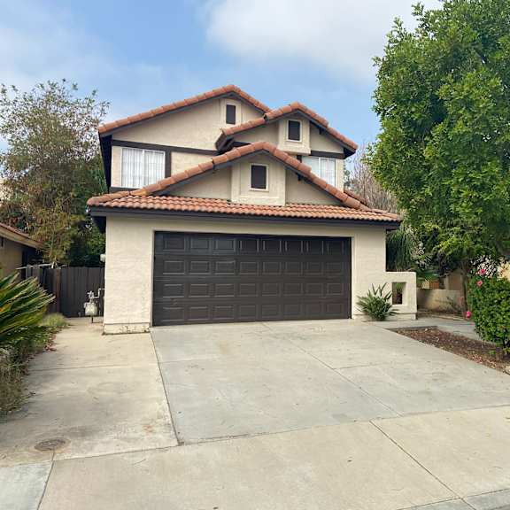 a house with a driveway and a garage door