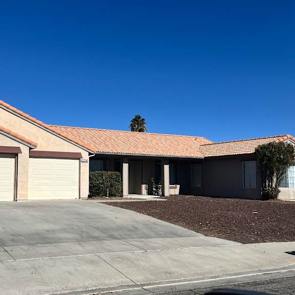 a house with a red tile roof and a white garage door.