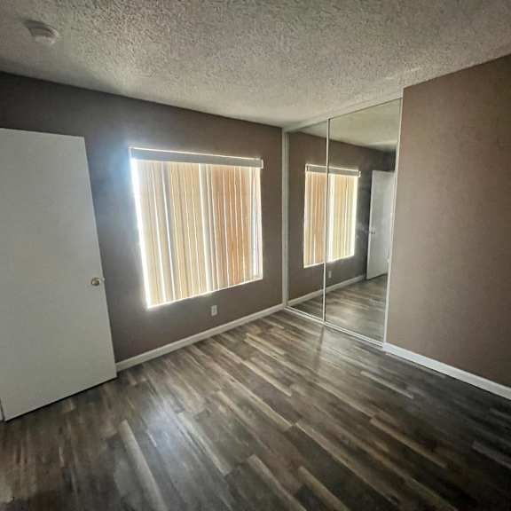a room with wooden floors and a white door.