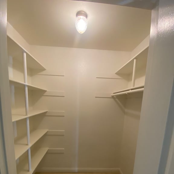 a white staircase with a light on the side.
