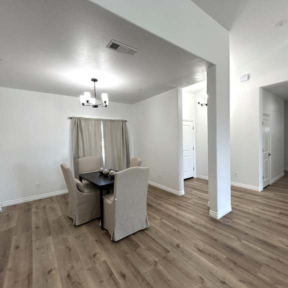 a room with a dining table and chairs.