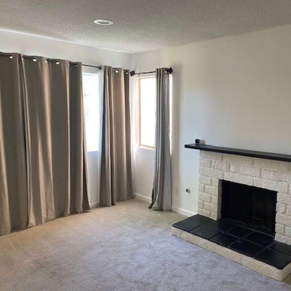 a room with a fireplace and curtains.