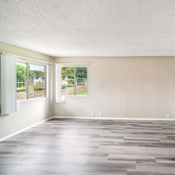 an empty room with a closet and a window