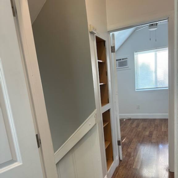 a small room with a staircase and a book shelf in it