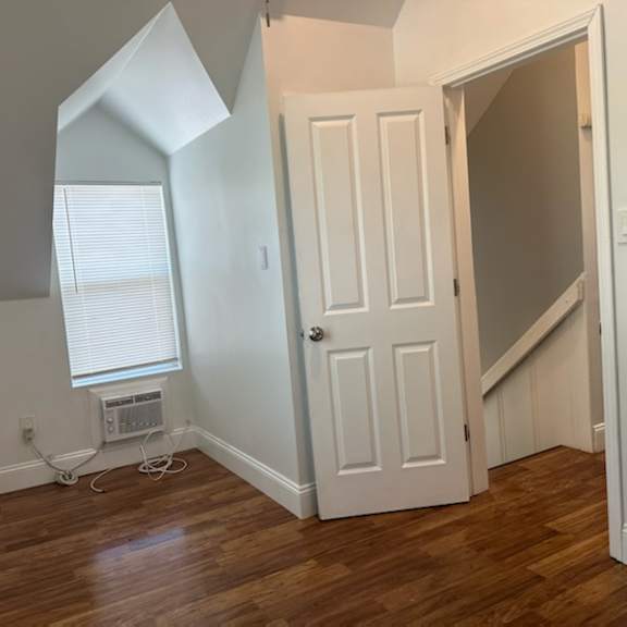an empty room with a door and a window