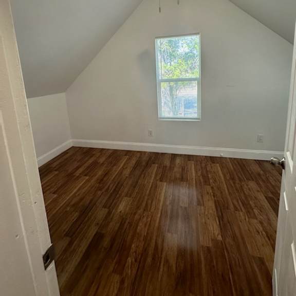 a room with hardwood floors and a ceiling fan