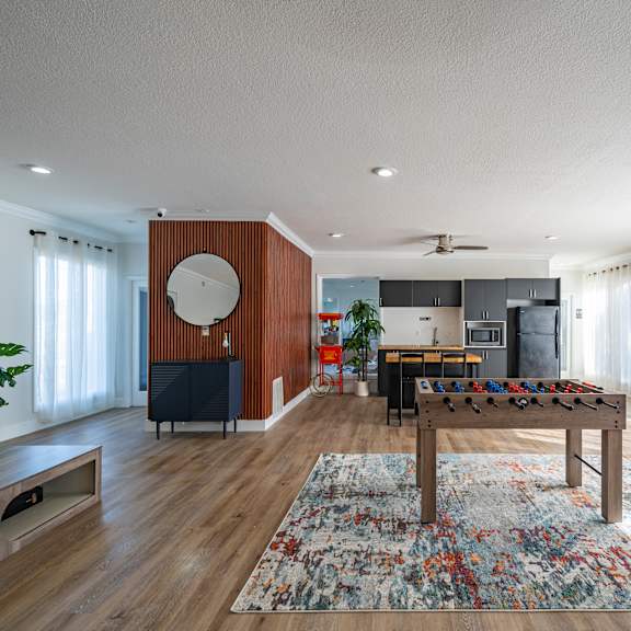 a living room with a wooden floor and a large rug. at red bay apartment complex, jacksonville, fl, 32211