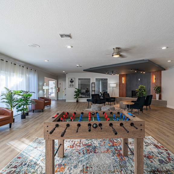 a room with a table and chairs and a rug on the floor. at red bay apartment complex, jacksonville, fl, 32211