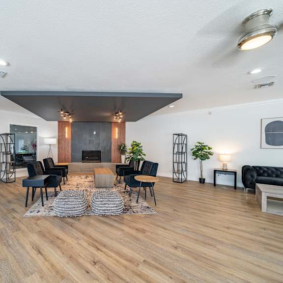 a modern living room with a fireplace and a black couch. at red bay apartment complex, jacksonville, fl, 32211