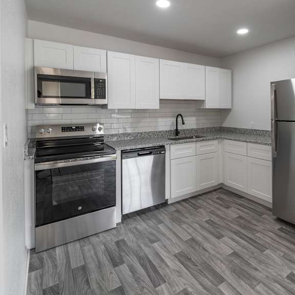 a kitchen with a refrigerator, oven, and microwave. at red bay apartment complex, jacksonville, fl, 32211