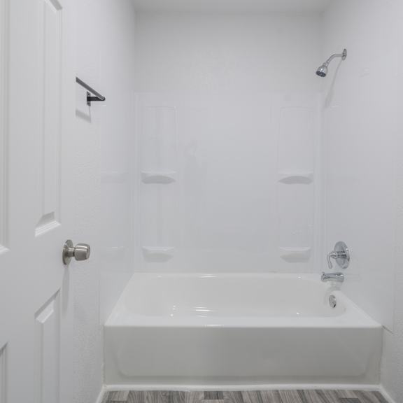 a white bathroom with a bathtub, toilet, and sink at red bay apartment complex, jacksonville, fl, 32211