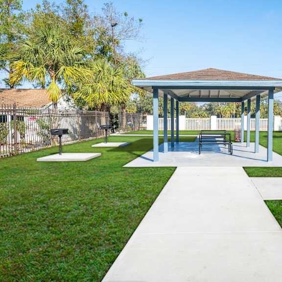 a pavilion with a white walkway in front of it. at red bay apartment complex, jacksonville, fl, 32211
