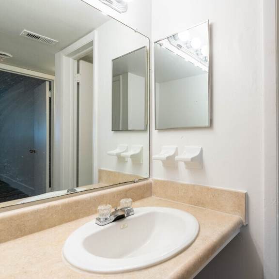 a bathroom with a sink and a mirror at red bay apartment complex, florida, 32211