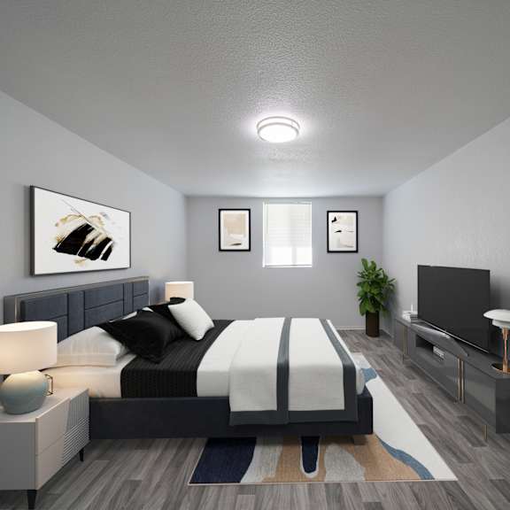 a modern bedroom with a large bed and a flat screen tv. at red bay apartment complex, jacksonville, fl, 32211