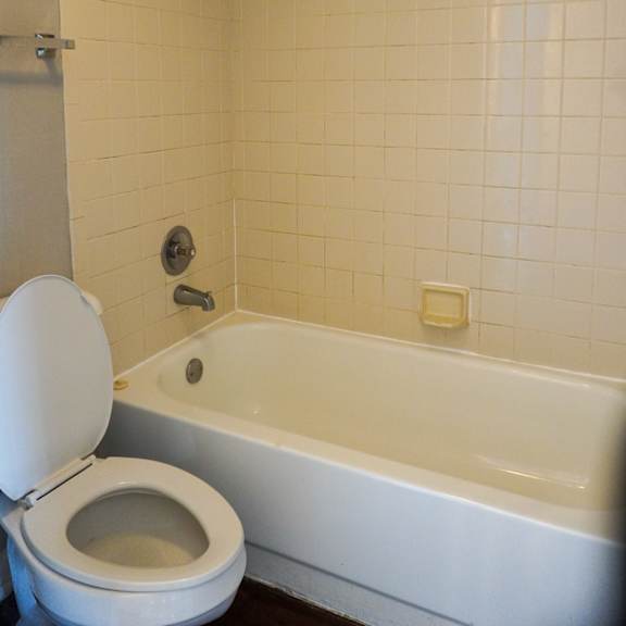 a bathroom with a toilet and a bath tub  at bella lago vista, florida, 33401