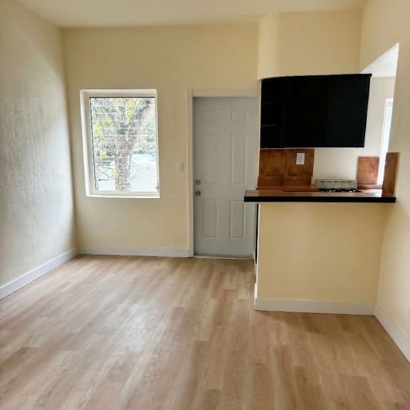 a room with a wooden floor and a window.