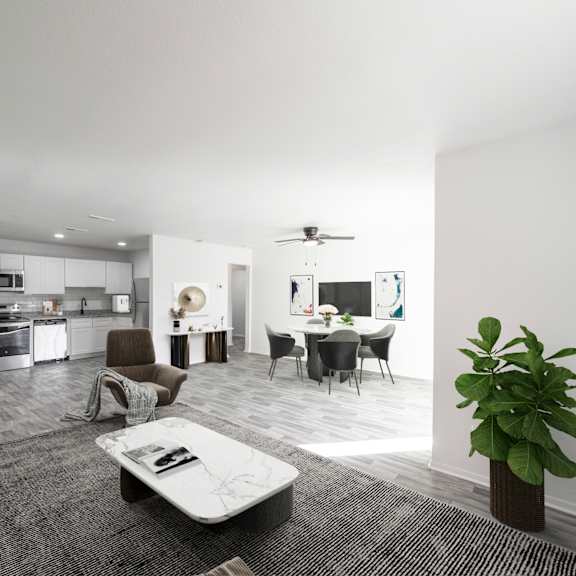 a modern living room with a grey sofa, a coffee table, and a dining area in the background. at red bay apartment complex, jacksonville, fl, 32211