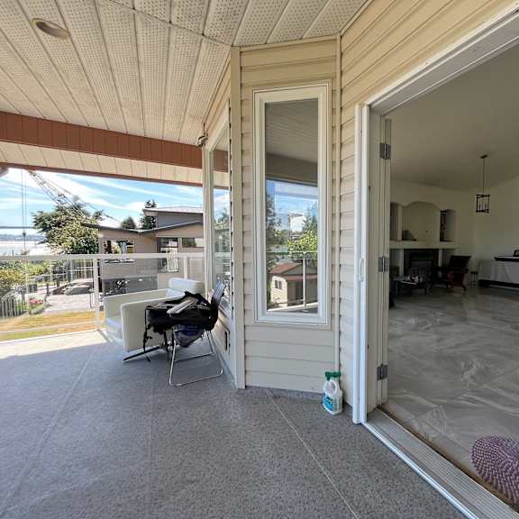 a patio with a table and chairs is visible through an open door.