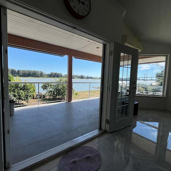 a room with a view of a lake through the windows.