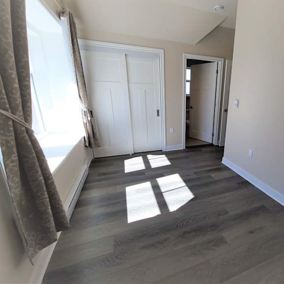 a room with a grey floor and white walls.