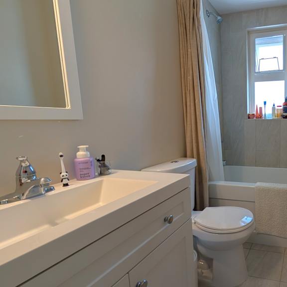 a bathroom with a toilet, sink, and bathtub.