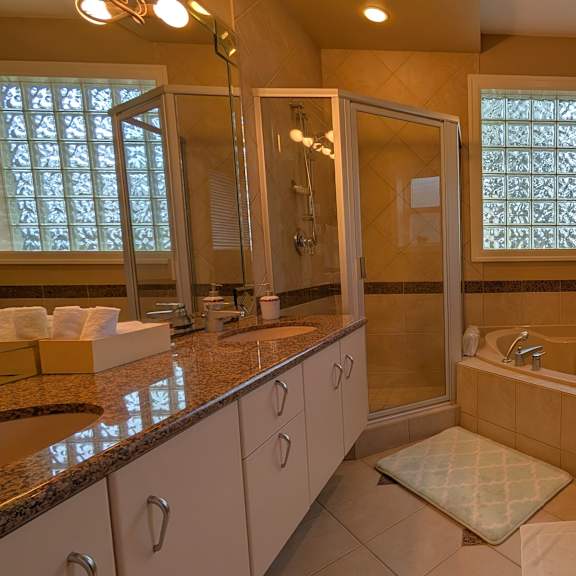 a bathroom with a tub, toilet, and sink.