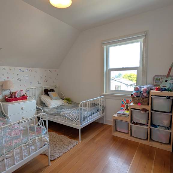 a room with two beds and a window.