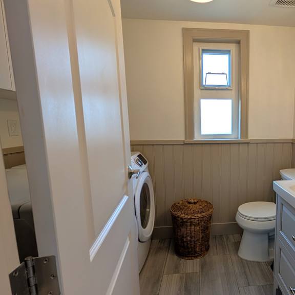 a small bathroom with a washer and dryer built in.
