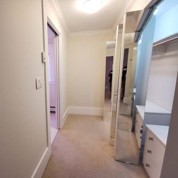 a hallway with a light switch on the wall.