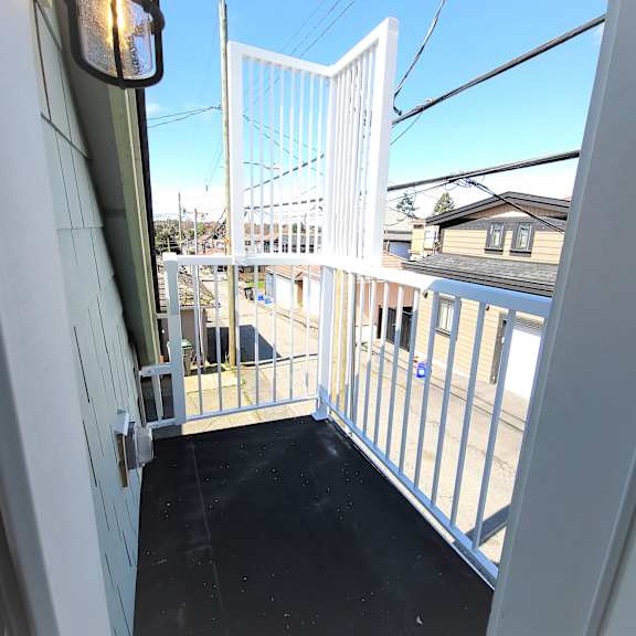 a view from inside a train looking out onto a residential area.