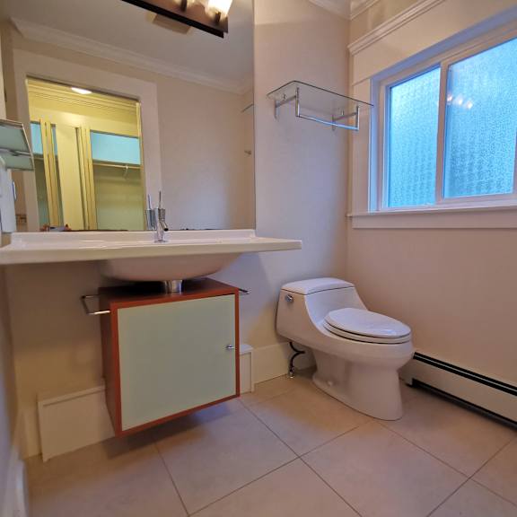 a white toilet sits next to a sink in a small bathroom.