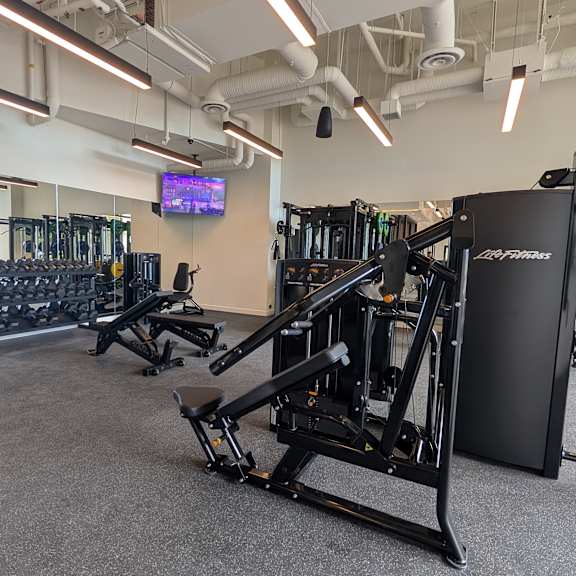 a gym with a variety of equipment including a rowing machine.