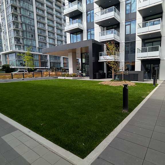a modern building with a grassy area in front.