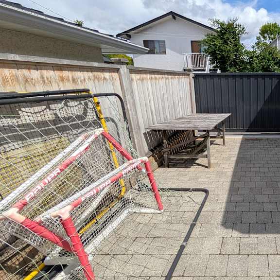 a backyard with a table and a fence.