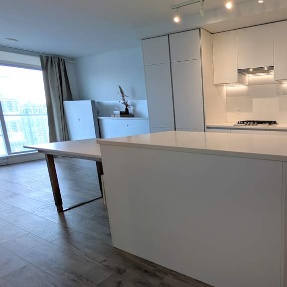 a kitchen with white cabinets and a large island.