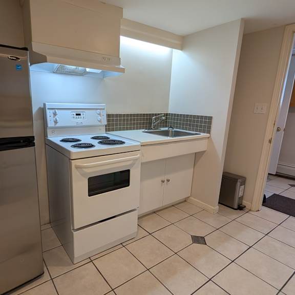 a kitchen with a stainless steel refrigerator and white appliances.