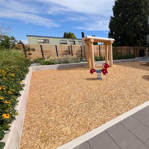 a playground with a swing set and a sandbox.