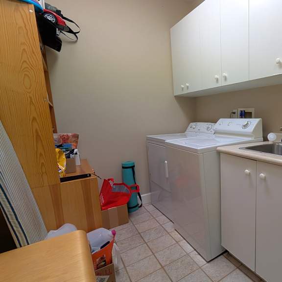 a small kitchen with white cabinets and a sink.