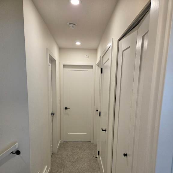 a white bathroom with a sink and a toilet.