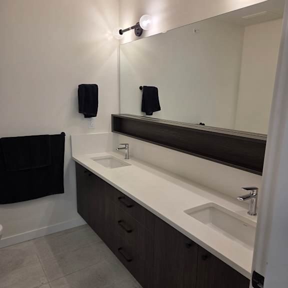 a bathroom with a black towel hanging on the wall.