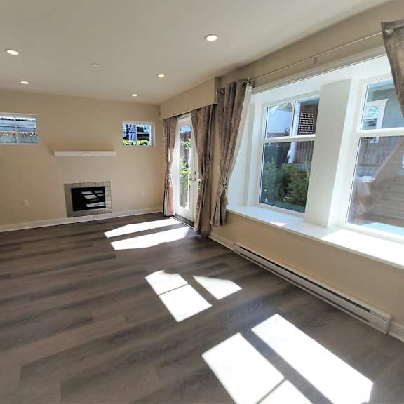 a room with wooden flooring and a fireplace.