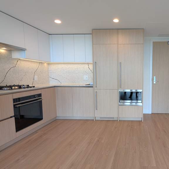 a kitchen with wooden floors and cabinets.