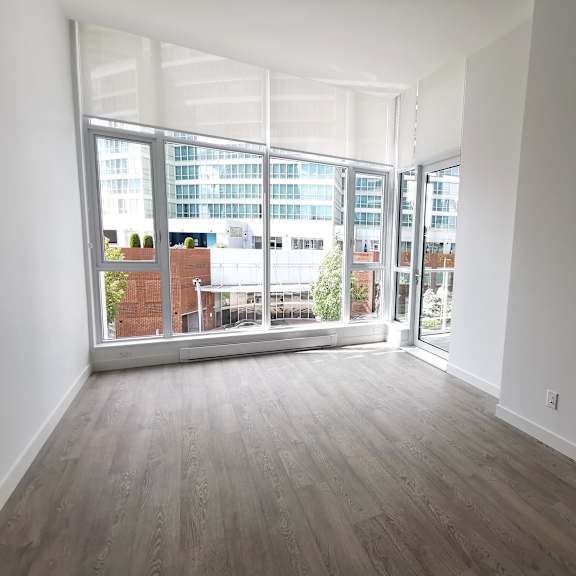 a room with a view of a cityscape through large windows.