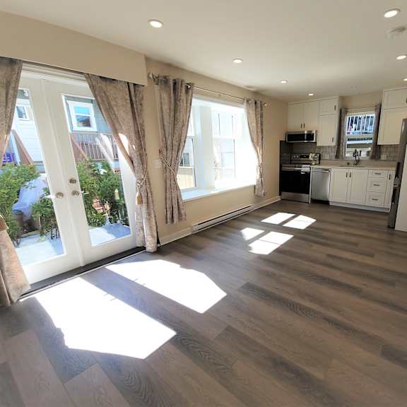 a sunny day in a spacious kitchen and living room.