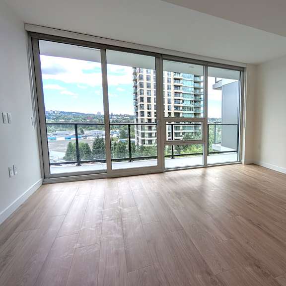 a room with a view of a cityscape through large windows.