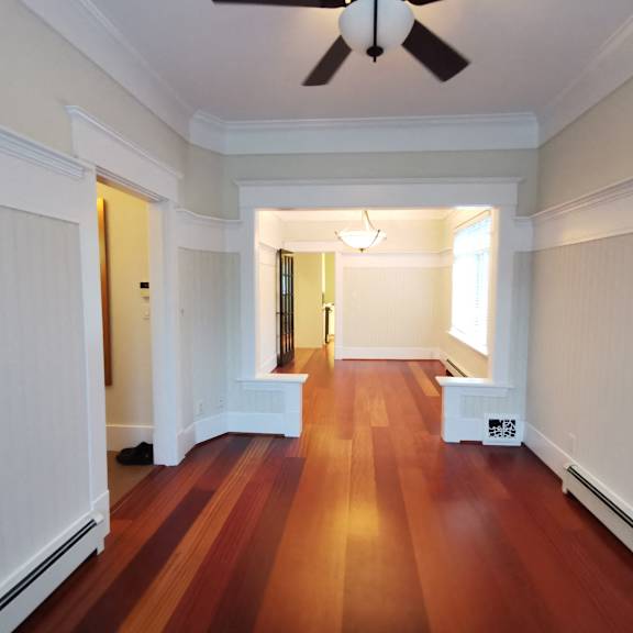 a room with wooden floors and white walls.